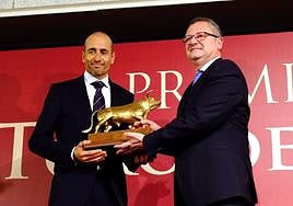 El consejero entrega el premio al ganadero galardonado.