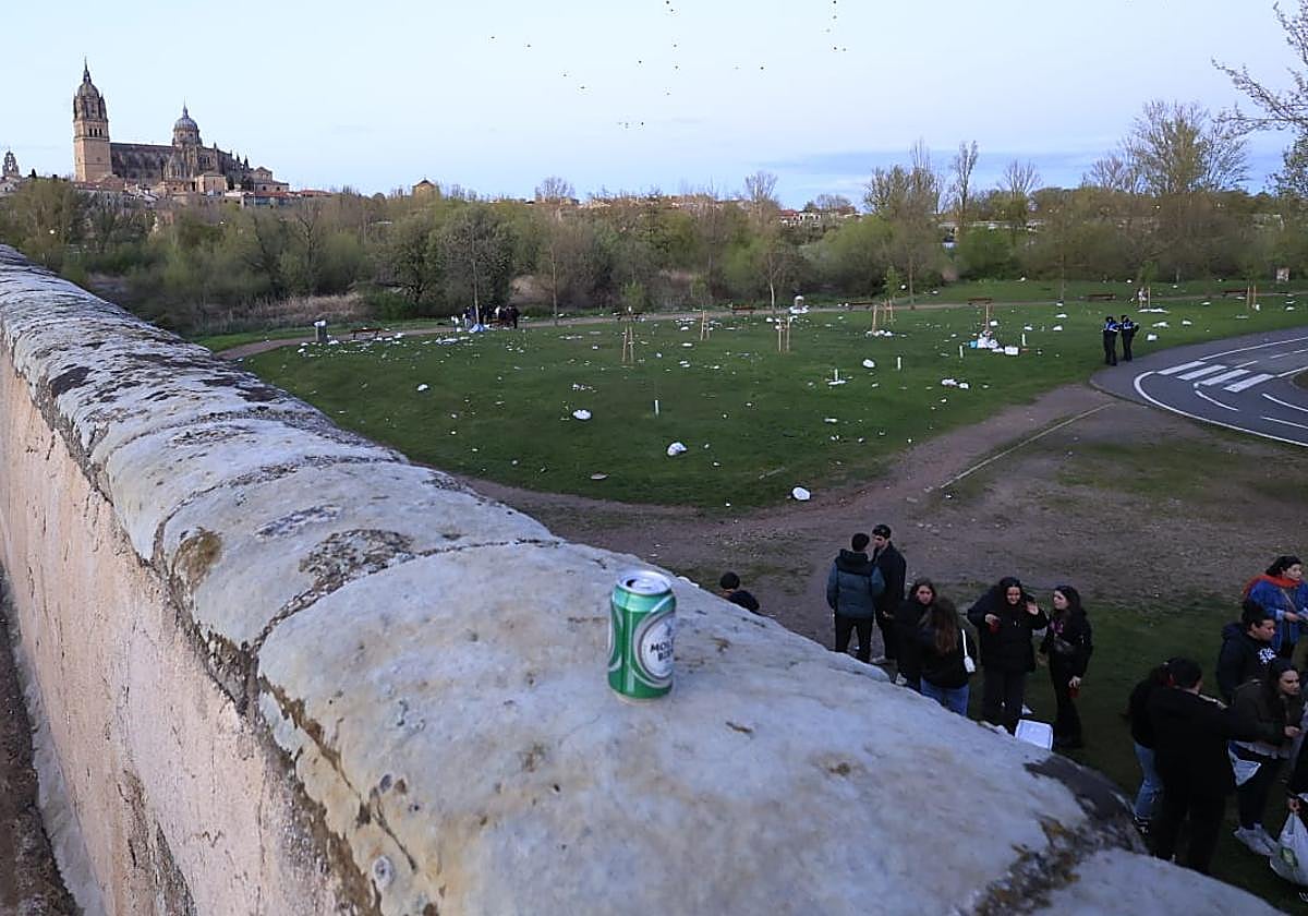 Una lata de cerveza, en el Puente Romano mientras varios jóvenes terminan la tarde del Lunes de Aguas en presencia de varios agentes de la Policía Local.