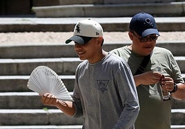 Un joven se abanica por el calor.