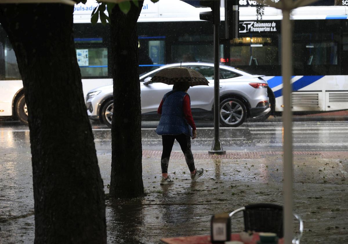 Imagen de archivo de una mujer en plena tormenta en Salamanca.