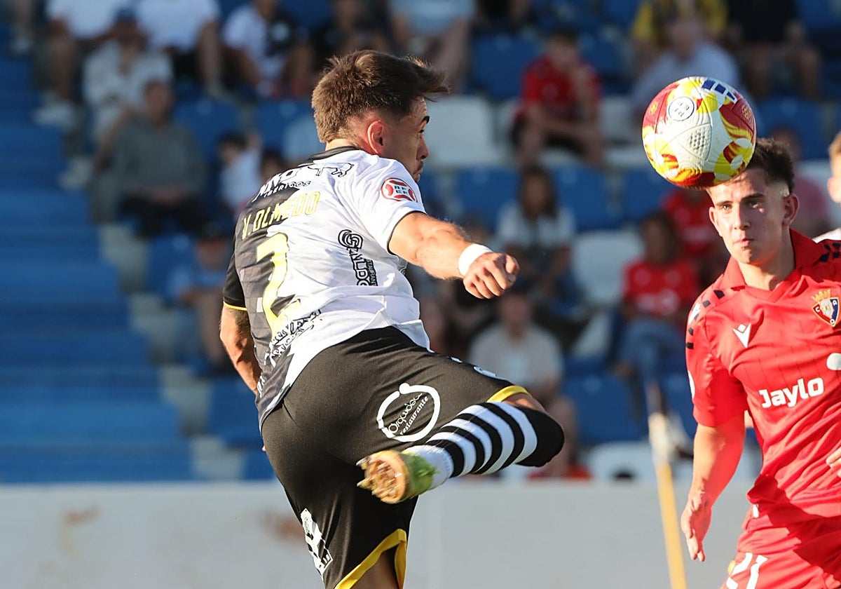 Víctor Olmedo remata el balón durante el choque