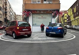 Dos coches aparcados sobre la acera al lado de un colegio este martes por la mañana.