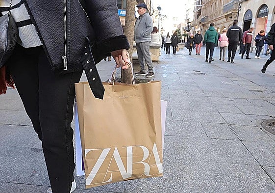 Una persona paseando por Salamanca con una bolsa de Zara