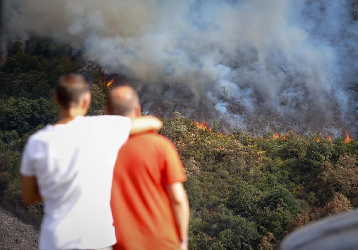 Mehrere Personen beobachten das Feuer in der Bergkette O Courel.