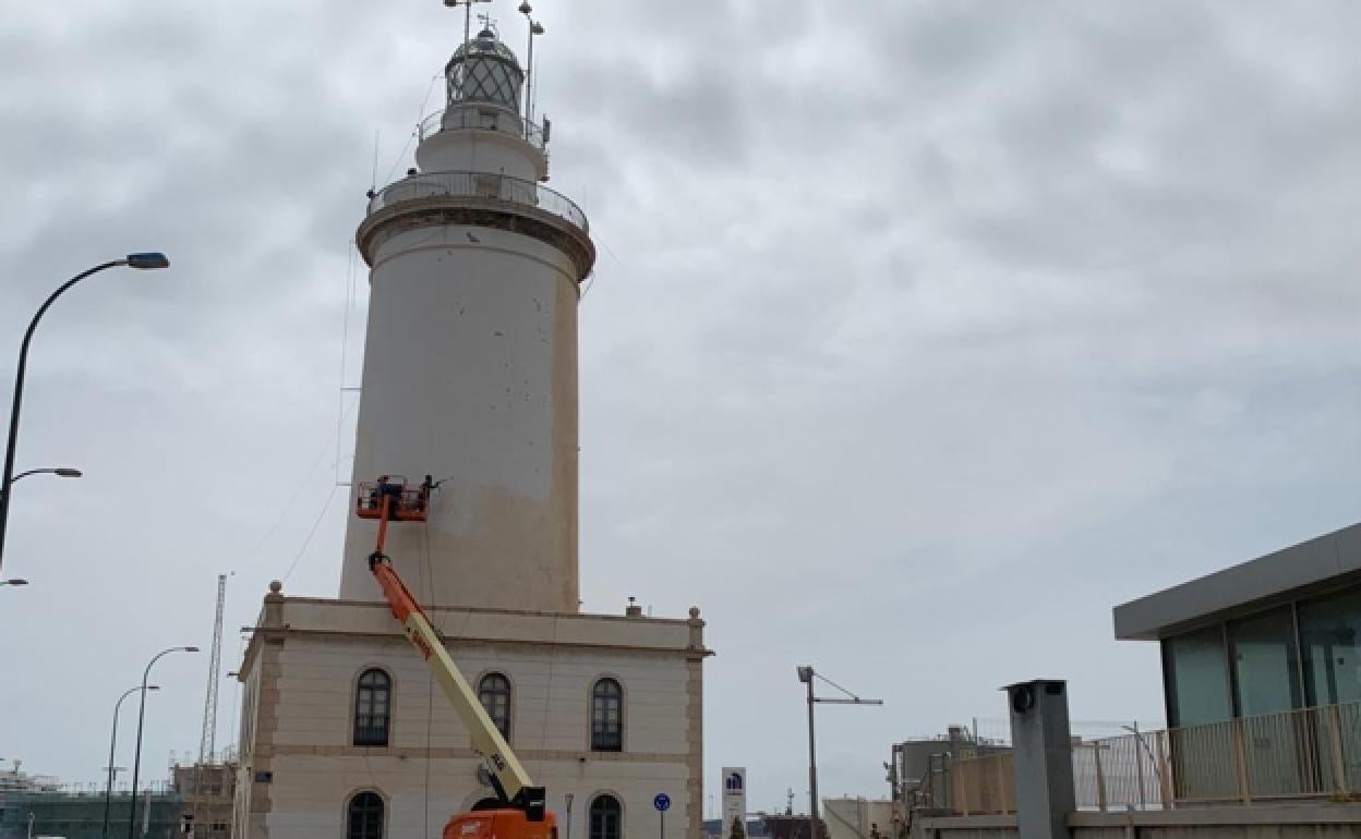 Orange dust is washed off Malaga's lighthouse.