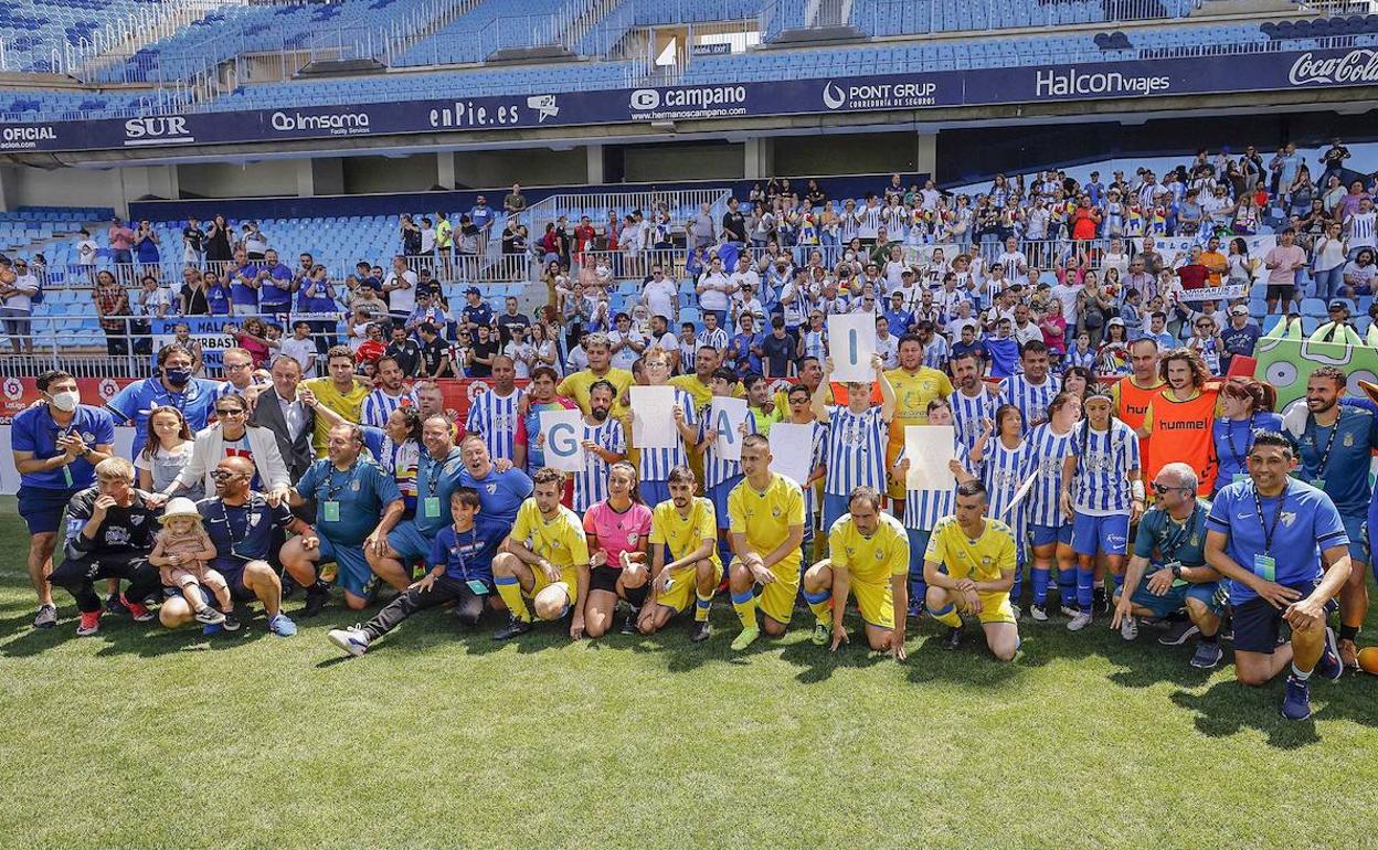 Malaga and Las Palmas Genuine teams pose together after the last game at La Rosaleda. 