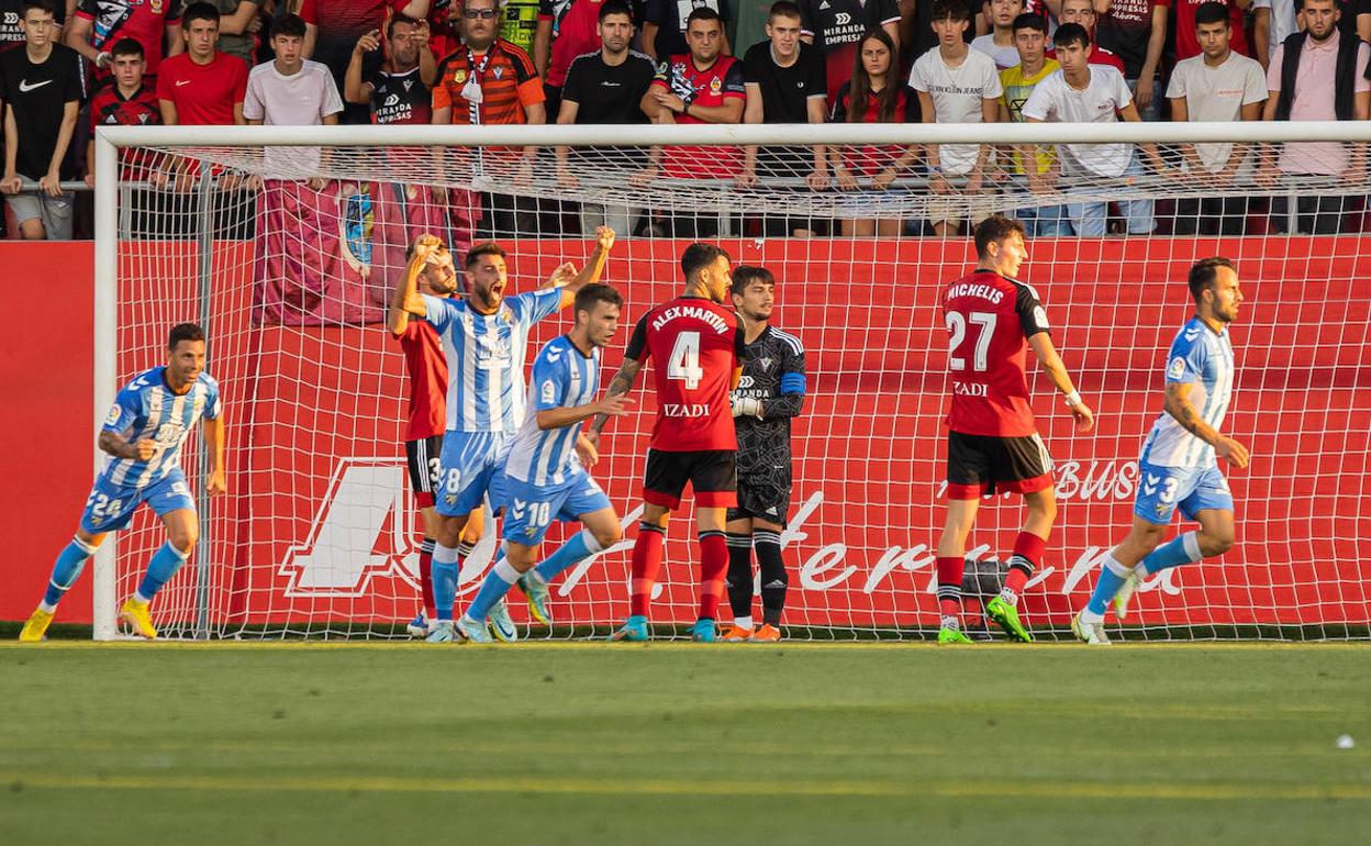 Malaga players celebrate Javi Jiménez's opening goal against Mirandés. 