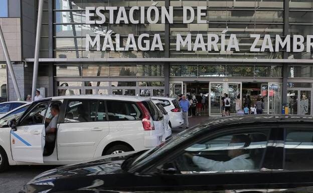 Taxis and a ride-hailing vehicle outside Malaga's main railway station. 