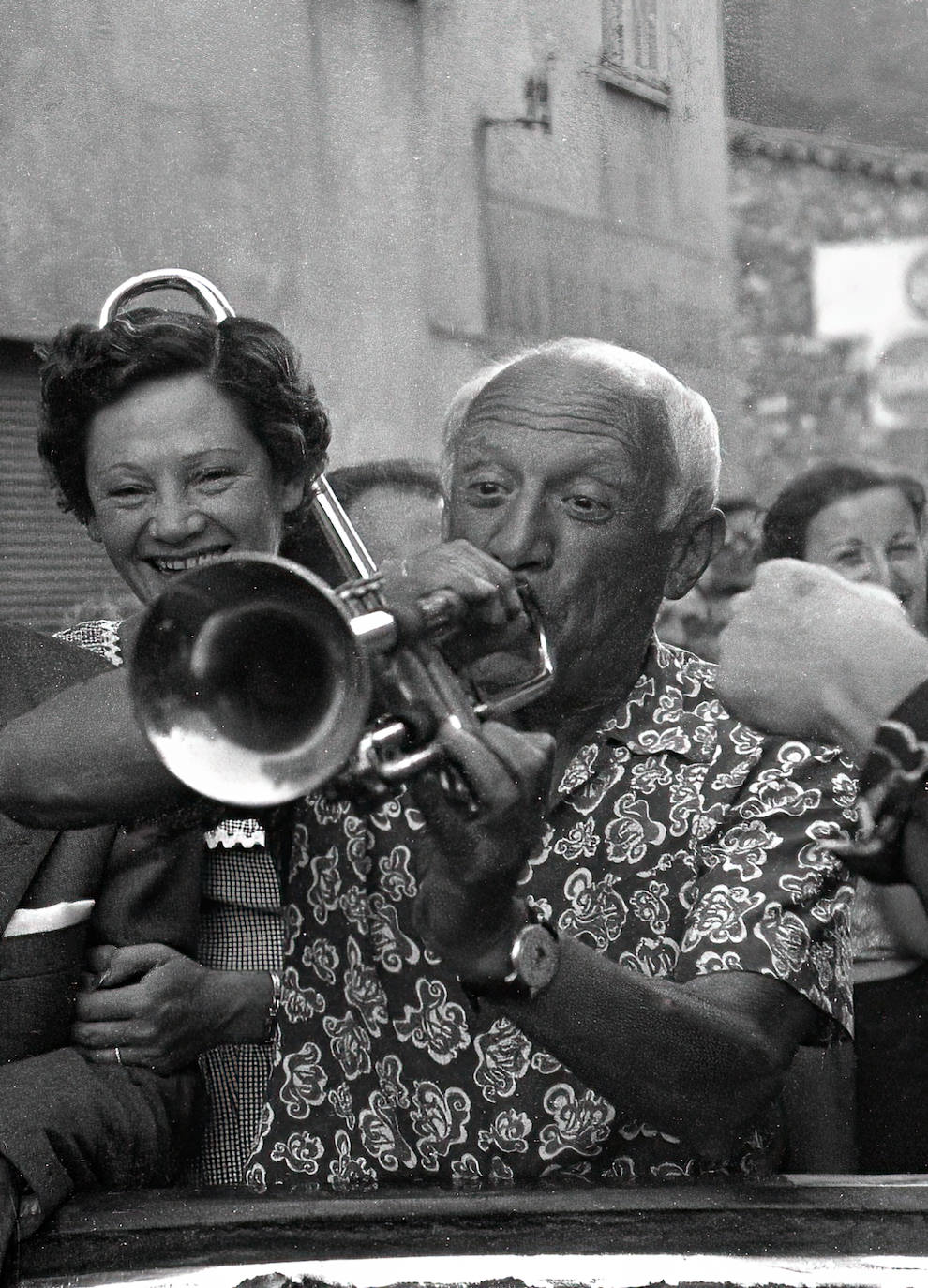 Picasso having fun with a trumpet, even though he didn't know how to play.