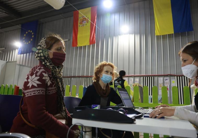 File image of Ukrainian refugees at an aid desk when they arrived in Malaga.