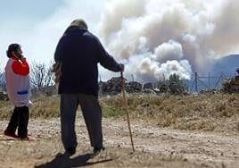 Residents watch the smoke form the fire get closer earlier this week.