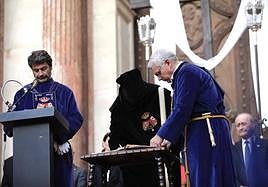 A cloaked Antonio Daniel is blessed with the pardon of Jesus El Rico.