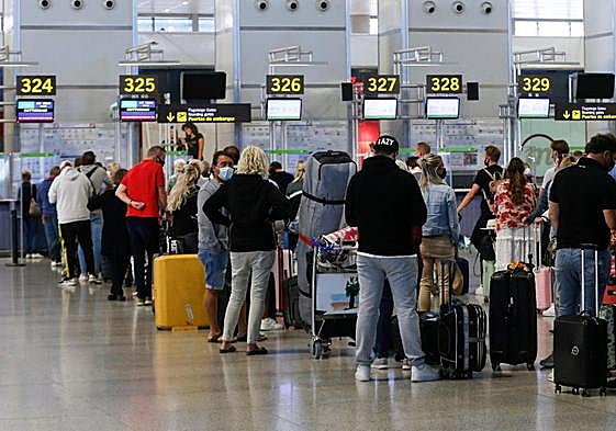 Stock image of passengers at Malaga Airport.