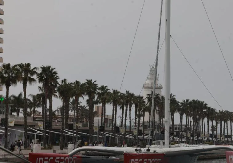 The trimaran in Malaga's mega yacht marina, with the lighthouse in the background.