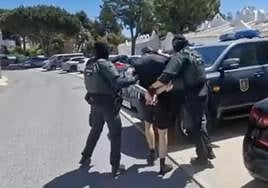 The individual is arrested by Guardia Civil officers.