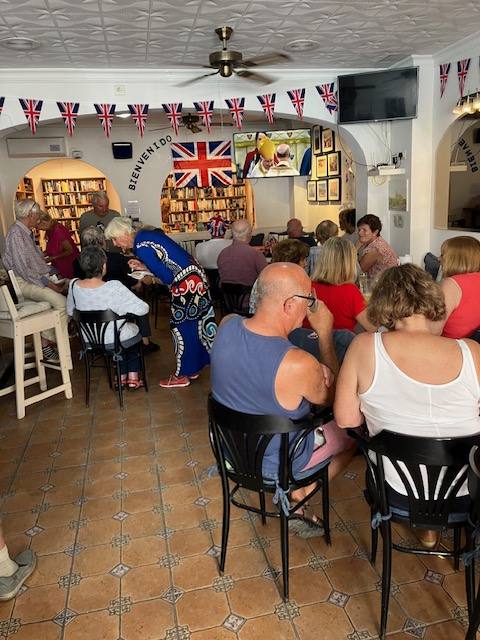 Members watch the coronation