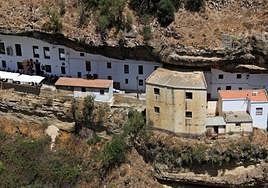 The distinctive houses and businesses wedged under the rocks.