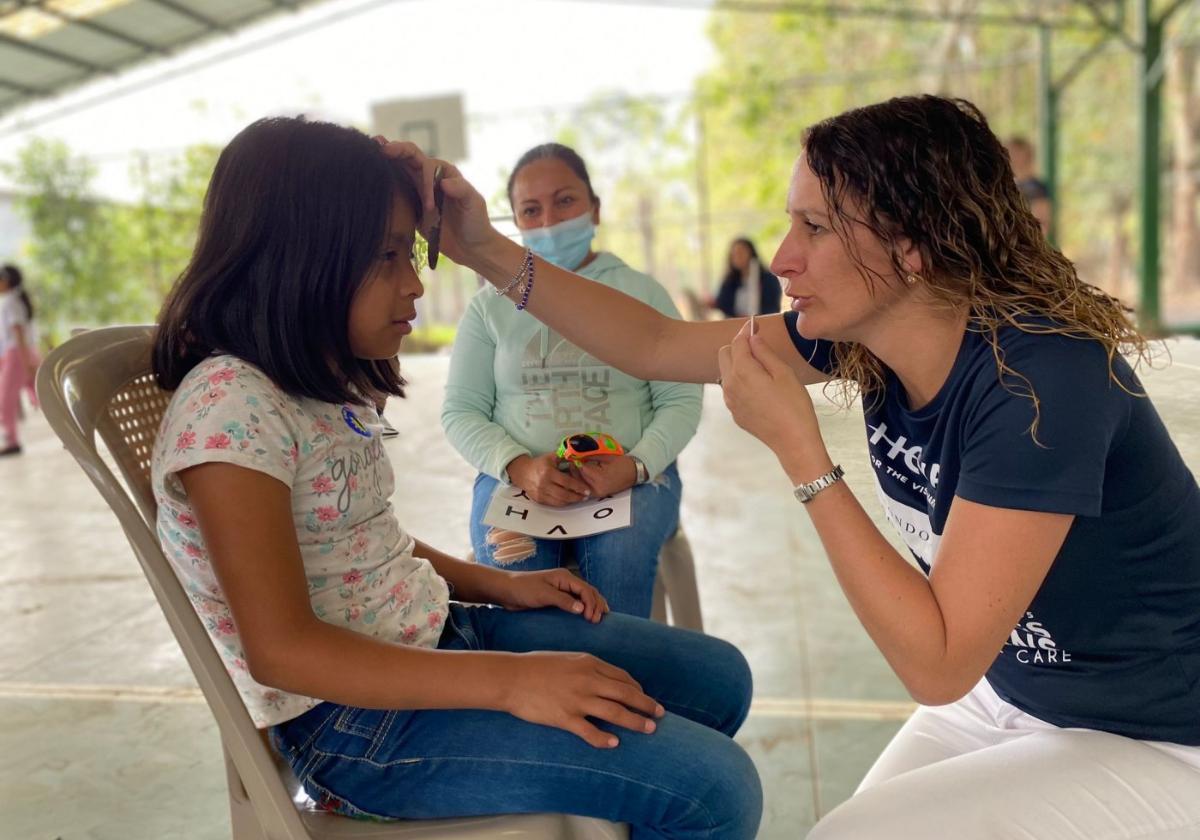 Michelle Brown examining the eye sight of a young girl.