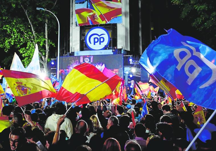 PP supporters celebrate outside their party's Madrid HQ on Sunday.