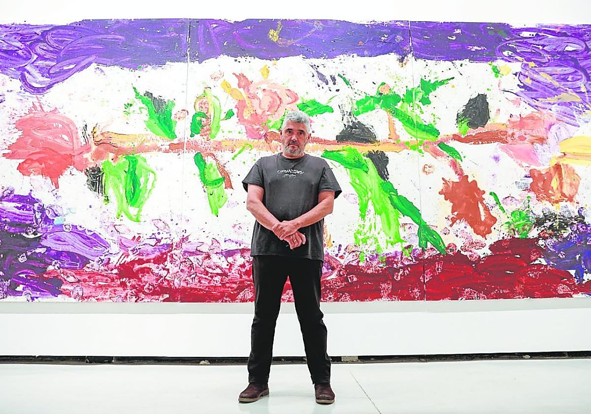 Jorge Galindo, standing before the triptych The Roses of Hercules.