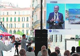 The mayor's presentation to delegates is relayed on a giant screen in the centre of Malaga.