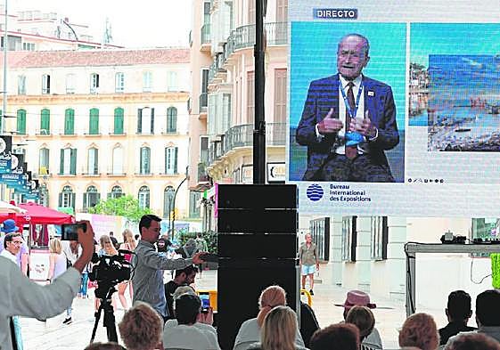 The mayor's presentation to delegates is relayed on a giant screen in the centre of Malaga.