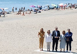 Bernal, together with his team, poses on a beach in Malaga city.