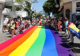 A large rainbow flag was unfolded on Main Street.