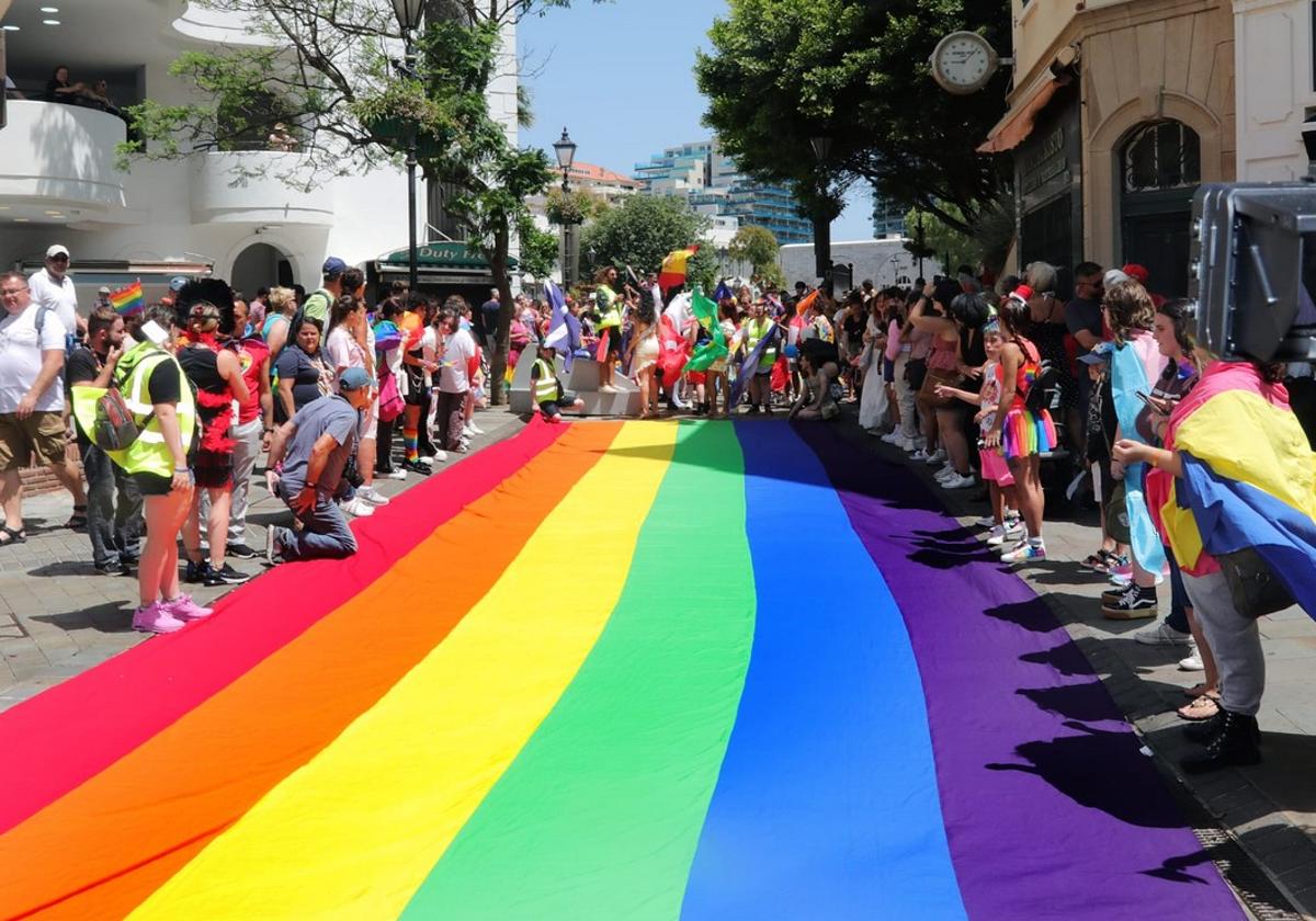 A large rainbow flag was unfolded on Main Street.