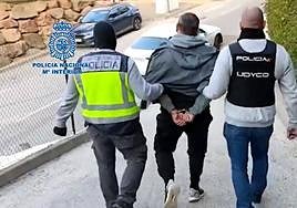 Police officers from the UDYCO unit escort a man arrested for belonging to a criminal gang.