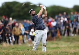 Rahm hits a shot during the third round of the Open.