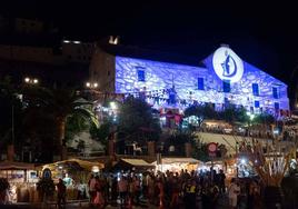 Frigiliana’s sugar cane factory lit up with three cultures symbol.