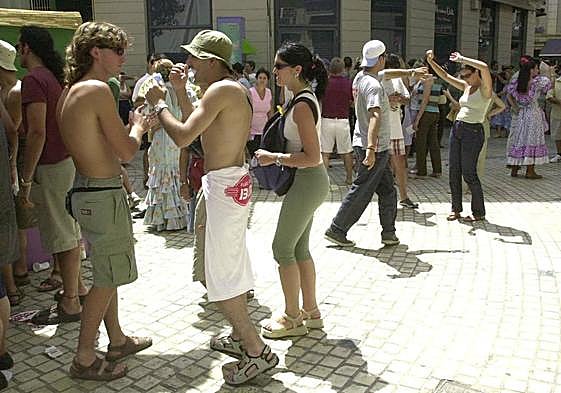 Two shirtless men in the city centre.