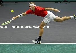 Davidovich struggles to reach a shot during his clash with Djokovic.
