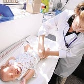 A health worker vaccinates a baby.
