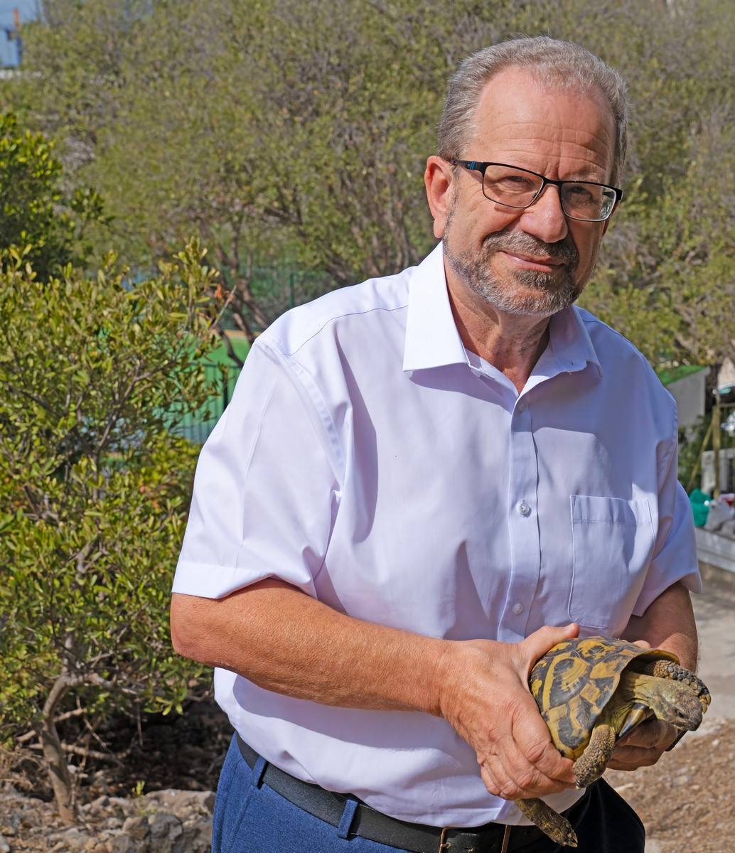 Prof. John Cortes with a tortoise.