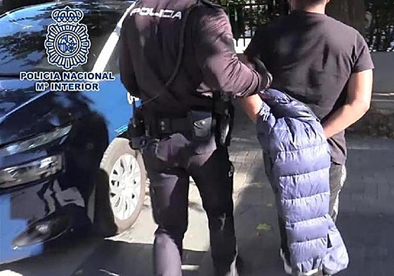A police officer arrests a minor offender.