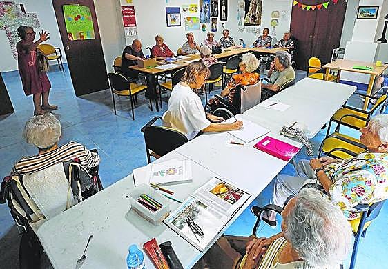 Residents and staff at a workshop at Élite, a care home in Malaga city.