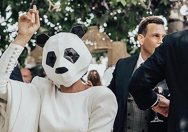 Bride dressed up in a panda mask.