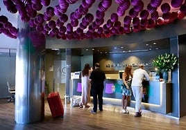 Tourists check in at a Malaga city centre hotel during the August fair.