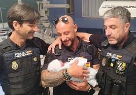 Little Ángela, with three of the police officers who rescued her after she was abandoned.