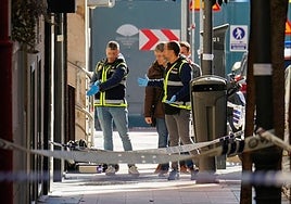 Police investigators at the scene of the shooting in Madrid on 9 November.