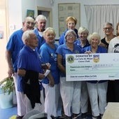 The Lions present the cheque to Apaffer volunteers.