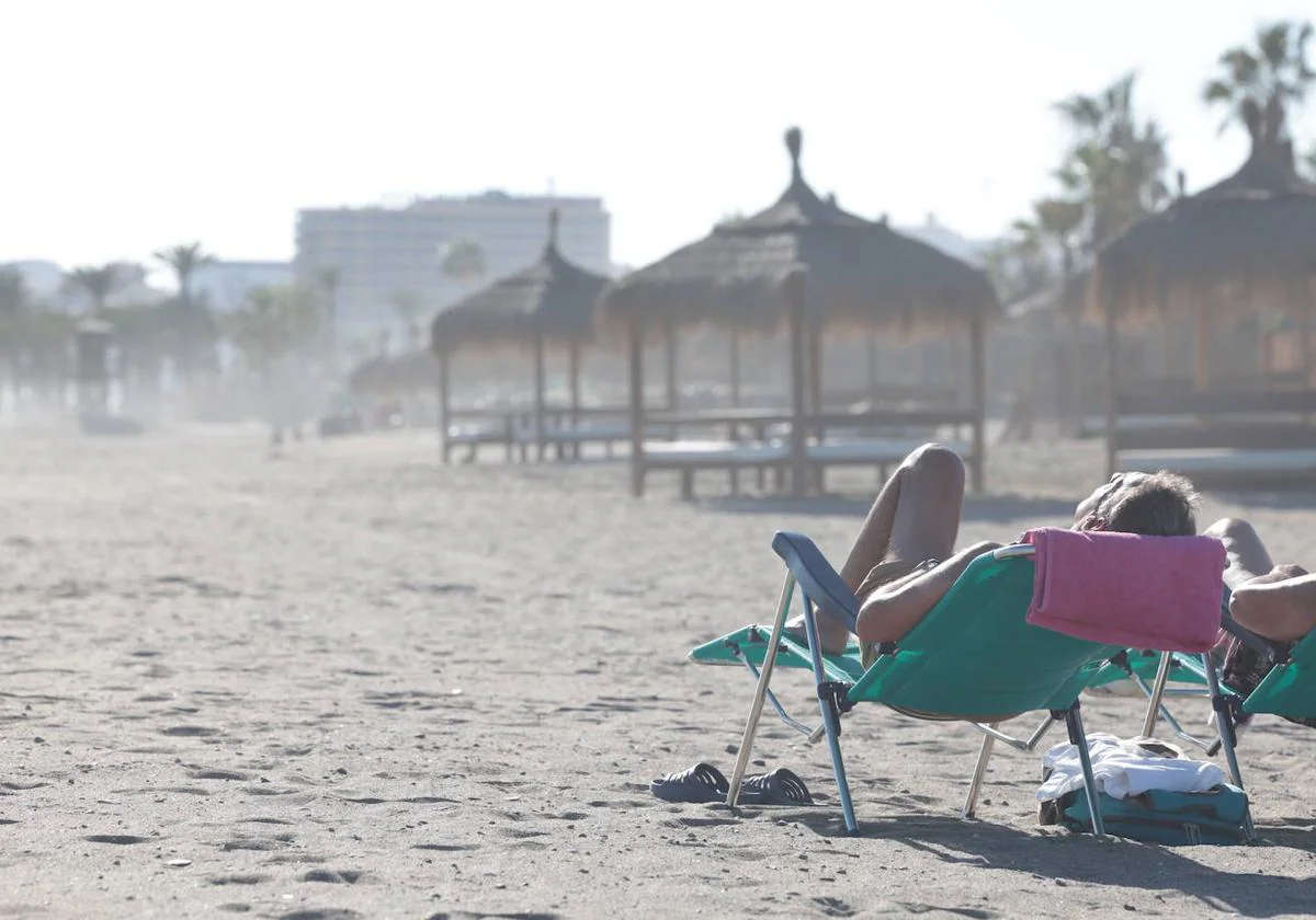 Two people sunbathing on Thursday at Los Álamos beach.