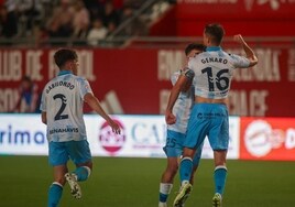Genaro celebrates levelling the scores for Malaga.
