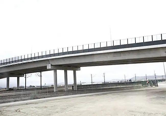 An extended bridge has been built over the railway lines alongside.