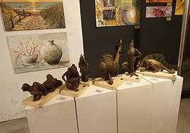 The exhibition includes sculptures and paintings.