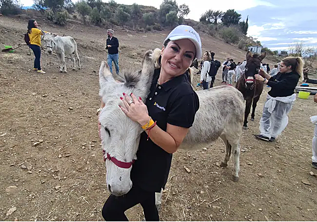 Project manager Violeta hugging one of the donkeys.