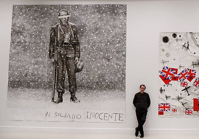 The artist Eduardo Gruber, in front of one of the large format works from the series 'The War'.