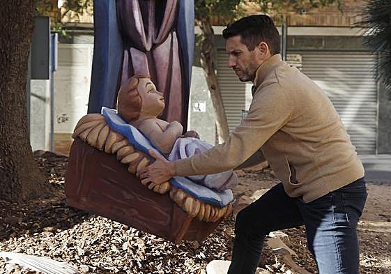 Then figure of the baby Jesus being placed back in the nativity scene.